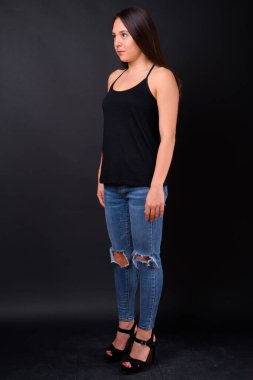 Studio shot of young multi ethnic beautiful woman against black background