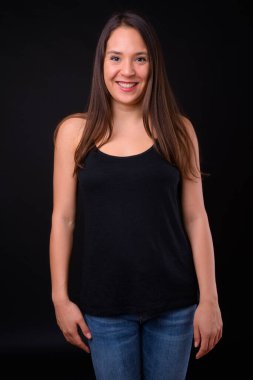 Studio shot of young multi ethnic beautiful woman against black background