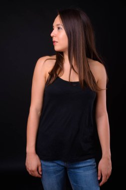 Studio shot of young multi ethnic beautiful woman against black background