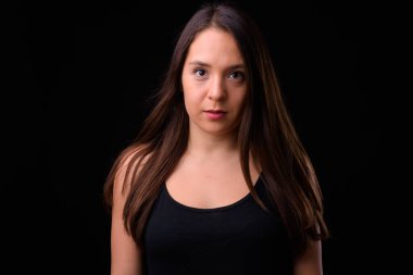 Studio shot of young multi ethnic beautiful woman against black background