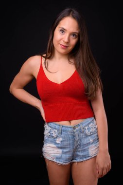 Studio shot of young multi ethnic beautiful woman against black background