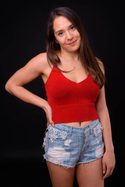 Studio shot of young multi ethnic beautiful woman against black background