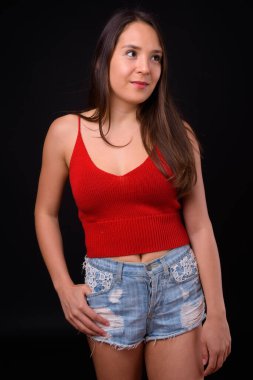 Studio shot of young multi ethnic beautiful woman against black background