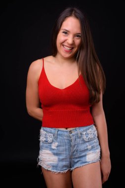 Studio shot of young multi ethnic beautiful woman against black background