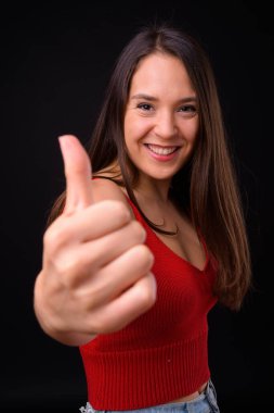 Studio shot of young multi ethnic beautiful woman against black background