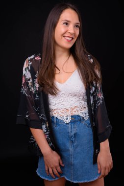 Studio shot of young multi ethnic beautiful woman against black background