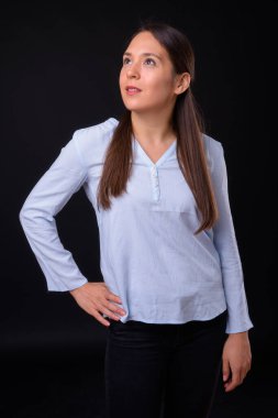 Studio shot of young multi ethnic beautiful businesswoman against black background