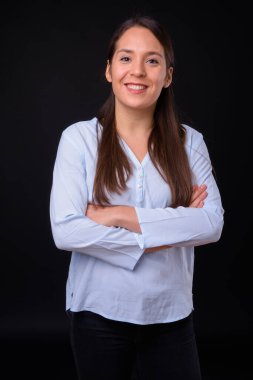 Studio shot of young multi ethnic beautiful businesswoman against black background