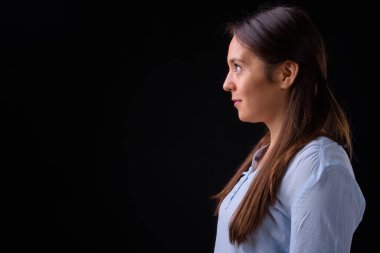 Studio shot of young multi ethnic beautiful businesswoman against black background