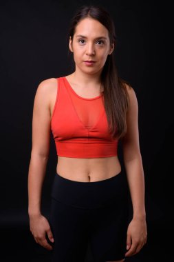 Studio shot of young multi ethnic beautiful woman ready for gym against black background