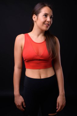 Studio shot of young multi ethnic beautiful woman ready for gym against black background