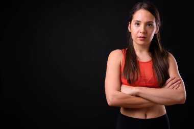 Studio shot of young multi ethnic beautiful woman ready for gym against black background