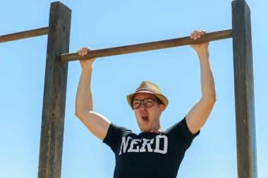 Portrait of young handsome tourist man as nerd at the beach in Spain