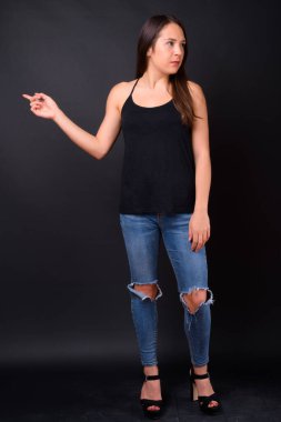 Studio shot of young multi ethnic beautiful woman against black background