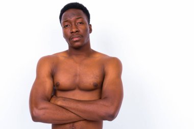 Studio shot of young handsome African man shirtless against white background
