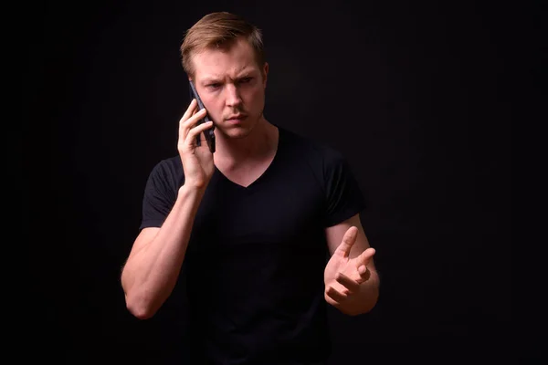 Наголошений молодий чоловік розмовляє по телефону — стокове фото