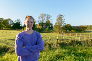 Portrait of young handsome Scandinavian man at the park in nature outdoors