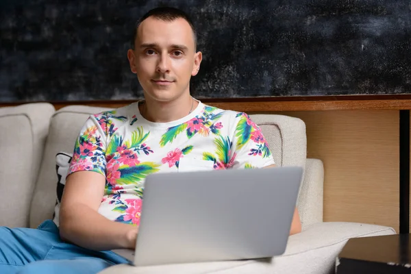 Portrait of handsome man in the living room at home