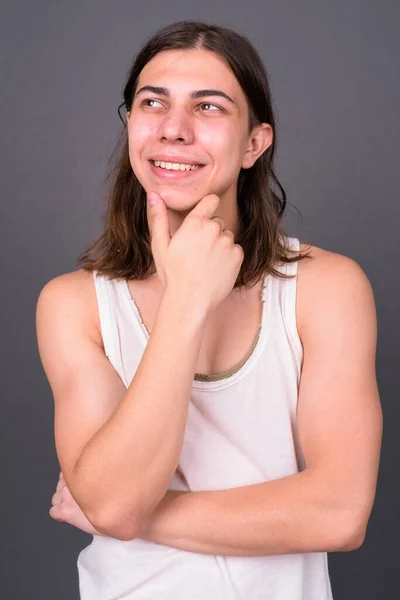 Studio Shot Young Handsome Androgynous Man Long Hair Gray Background — Stockfoto