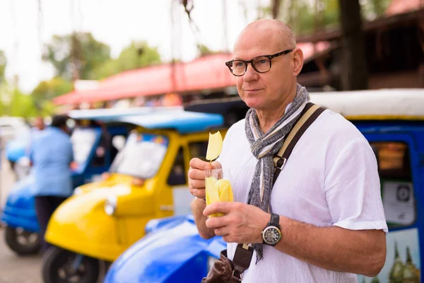 Portrait of senior Scandinavian tourist man spending vacation in Ayutthaya city of Thailand