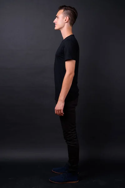 Full body shot profile view of young handsome man — Stock Photo, Image