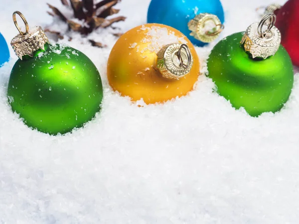 Christmas baubles in snow — Stock Photo, Image