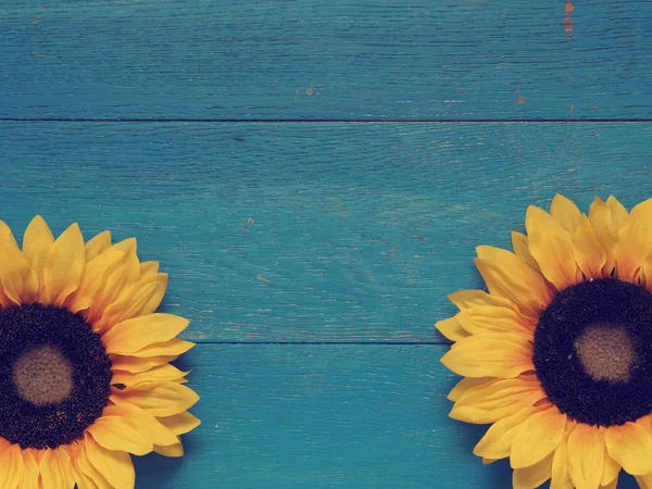 Sunflowers on blue wood — Stock Photo, Image