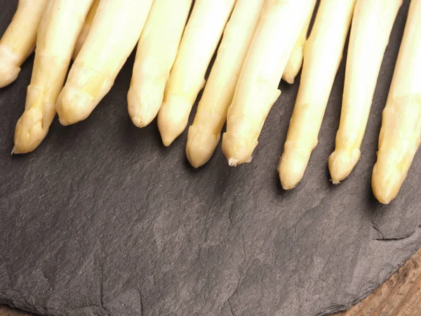 Koyu slate üzerinde beyaz kuşkonmaz