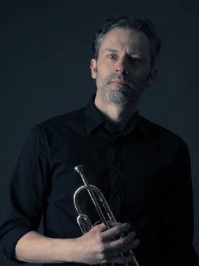 Dark portrait of a brass musician clipart