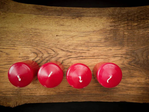 Four red candles on wood — Stock Photo, Image