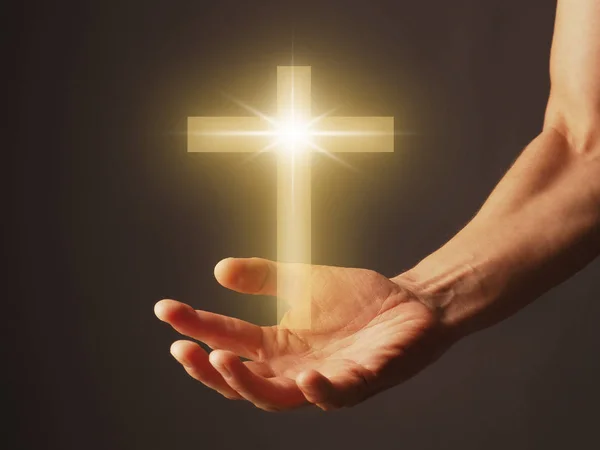 Hand with a shining cross — Stock Photo, Image