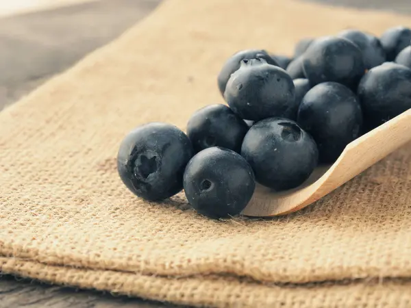 Fresh blueberries on a wooden spoon — Stock Photo, Image
