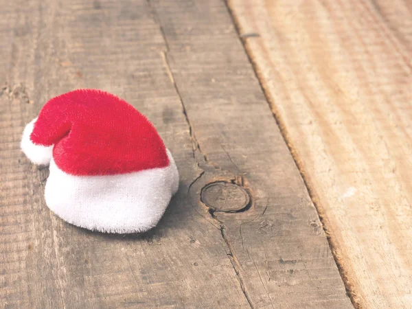 Tiny little hat of Santa on wood — Stock Photo, Image