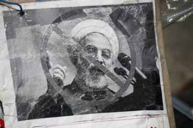protest poster with a portrait of Iranian President Hassan Rohani  clipart
