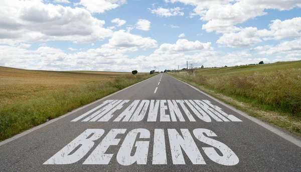 The adventure begins message written on the road — Stock Photo, Image