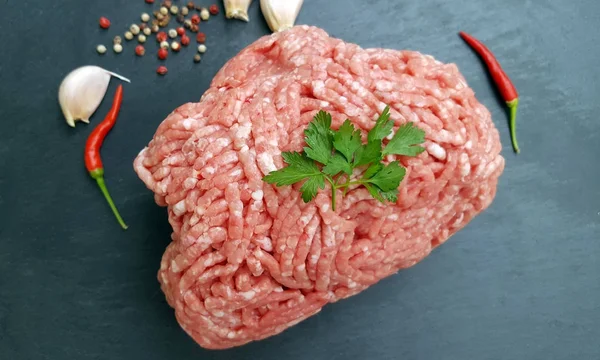 Fresh minced meat on dark stone background — Stock Photo, Image
