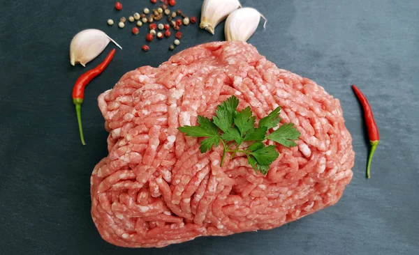Fresh minced meat on dark stone background — Stock Photo, Image