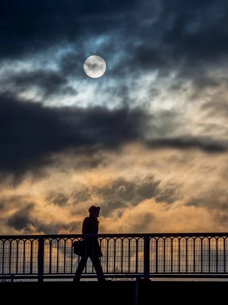 Lonely person with clouds and sun — Stock Photo, Image