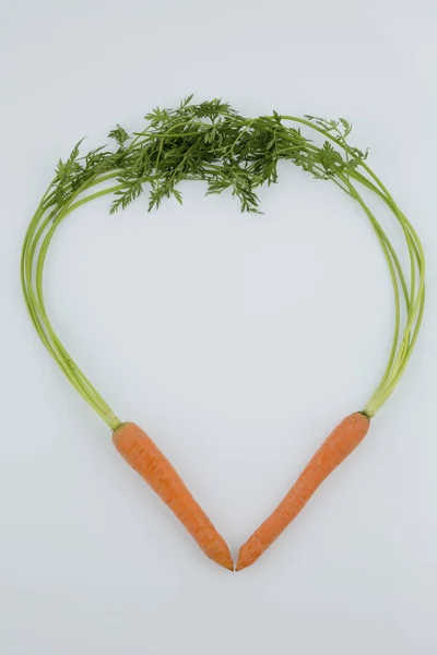 Fresh carrots in a heart shape — Stock Photo, Image
