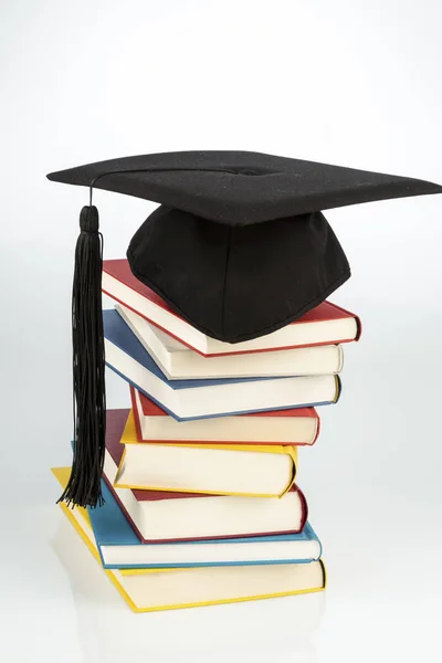 Mortar board on books stack — Stock Photo, Image
