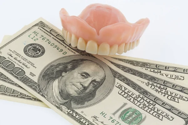 Dentures and dollar bills — Stock Photo, Image