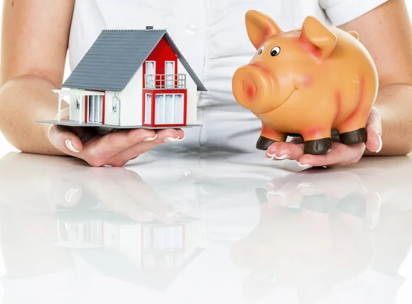 woman with house and piggy bank