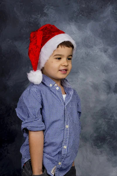 Malý chlapec s santa claus klobouk — Stock fotografie