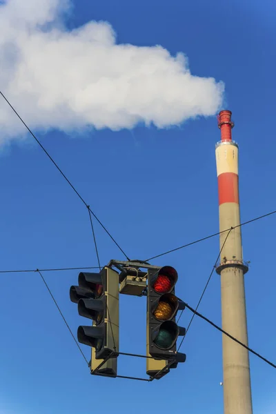 Industrial chimney and red traffic light — Stock Photo, Image