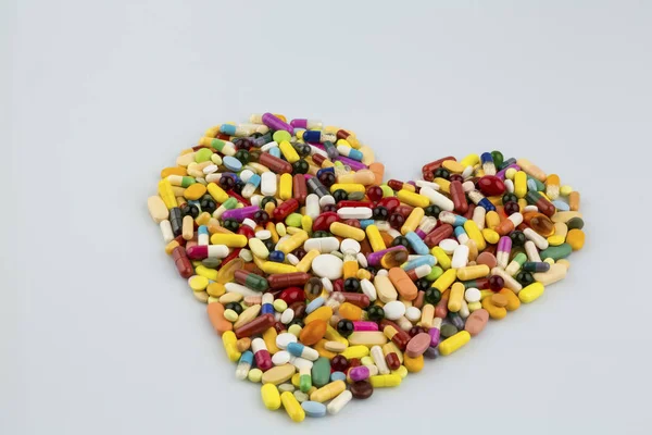 Colorful tablets in heart shape — Stock Photo, Image