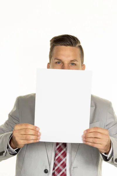 Manager holds blank sheet in front of face — Stock Photo, Image