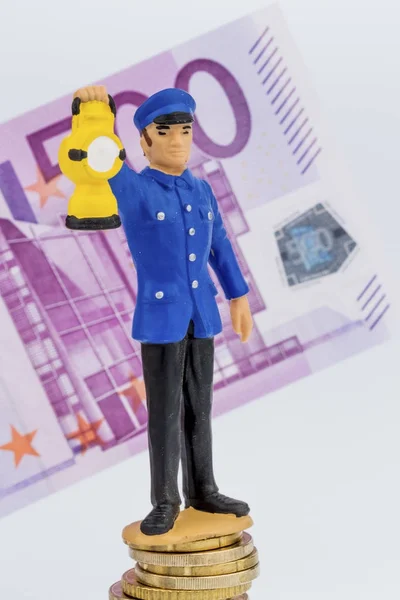 Railway employee stands on money pile — Stock Photo, Image