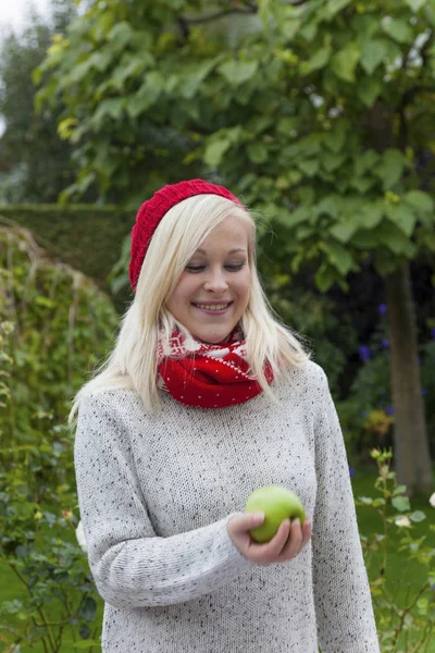 Woman with apple. vitamins in the fall — Stock Photo, Image