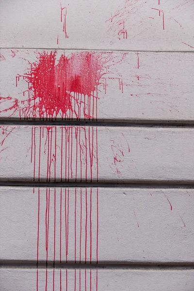 Red paint splashes on a wall — Stock Photo, Image