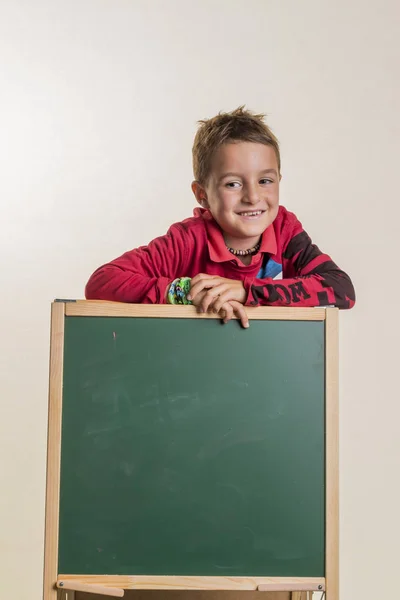 Schoolchild with school blackboard — Stock Photo, Image